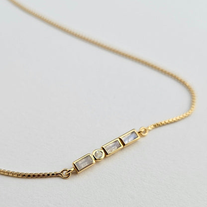 Close-up of 18k gold vermeil Morse Code necklace showing intricate dot and dash beadwork.
