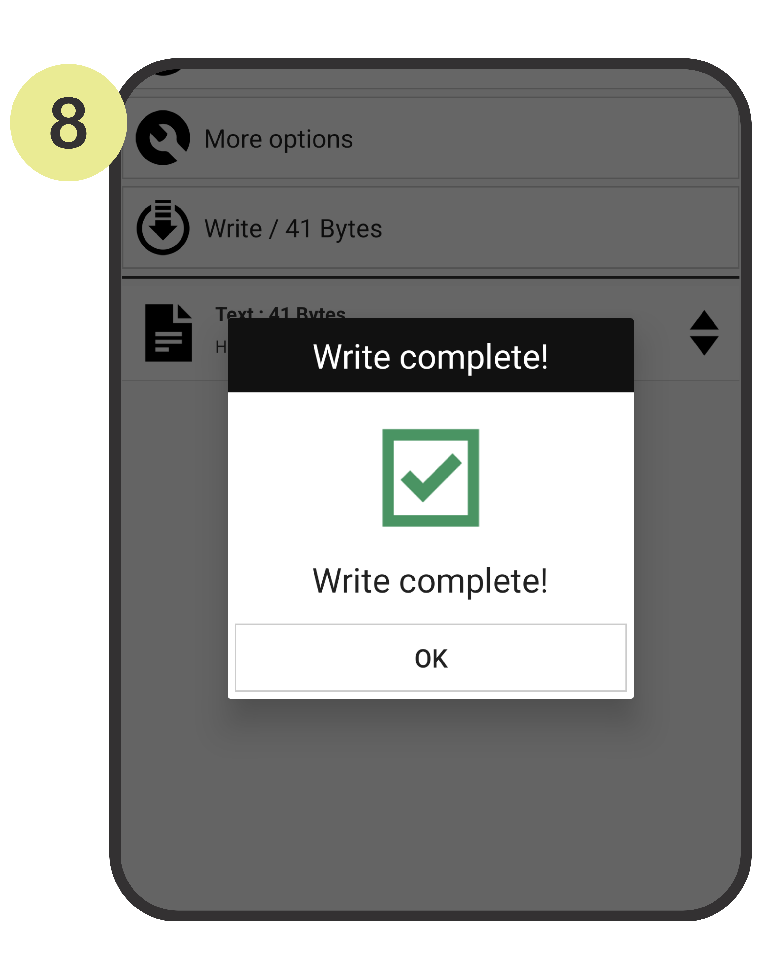 Phone screen showing a 'Write complete!' confirmation dialog with a green checkmark on a gray background.