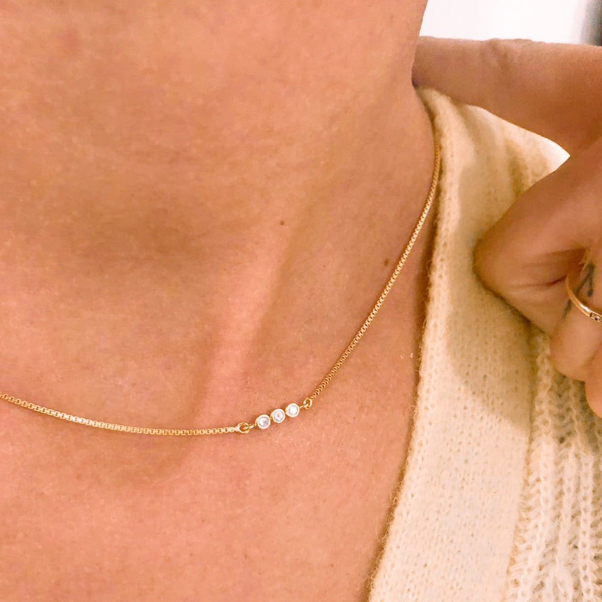 Dainty 18k gold vermeil letter 'S' Morse Code necklace with delicate moonstone beads, showcasing its subtle elegance.