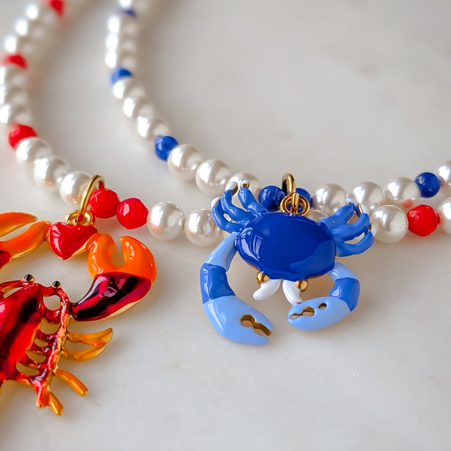 Necklace with colorful crab and lobster pendants on a white background