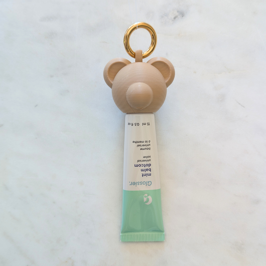 Teddy Bear portable lip balm case for easy access.